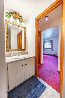 a spacious bedroom with a bed and a chandelier