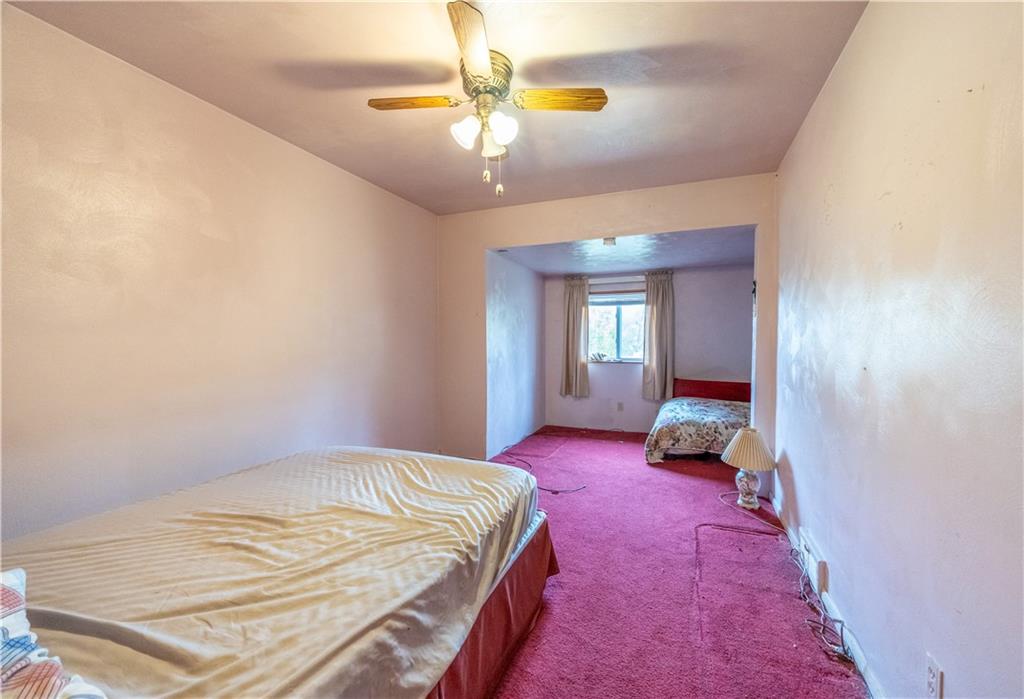520 Farneth Road New Kensington, PA 15068 - Photo 12 of 20 a spacious bedroom with a bed and a chandelier