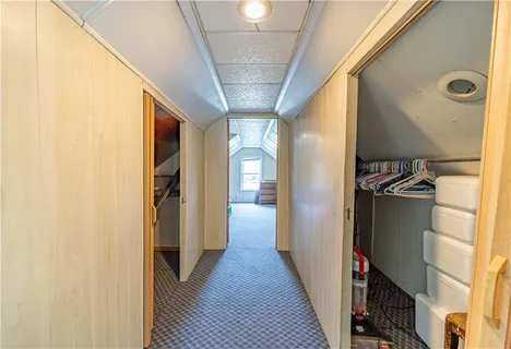 a living room with furniture a flat screen tv and a window
