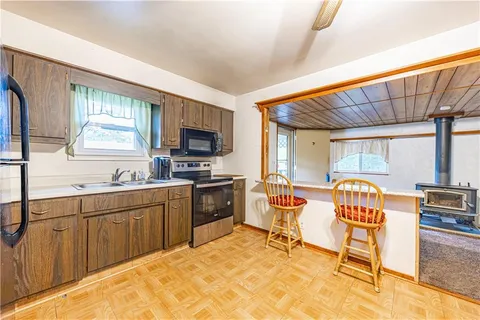 a kitchen with a refrigerator stove and sink