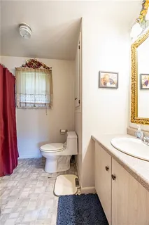 a view of a hallway with wooden floor windows and a rug
