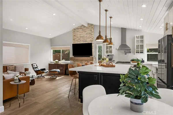 a living room with furniture a chandelier and a fireplace