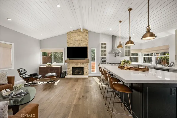 a living room with furniture a fireplace and a flat screen tv
