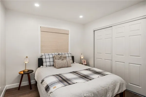 a bathroom with a granite countertop toilet sink and mirror