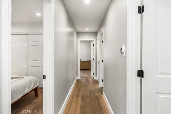a bathroom with a granite countertop toilet sink and mirror