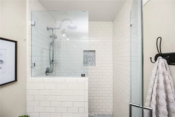 a bedroom with a bed and a night stand