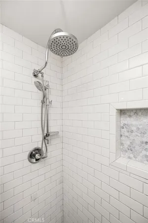 a view of a white house next to a road and palm trees