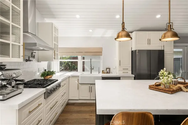 a view of kitchen with granite countertop cabinets and dining table