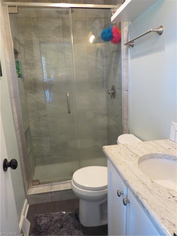 116 Longbow Road Reidsville, NC 27320 - Photo 11 of 20 Master bathroom with granite counter top and tiled walk in shower.