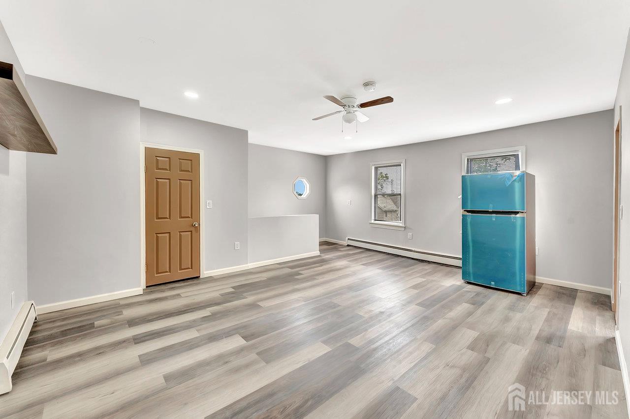 601 Ridgeway Avenue South Amboy, NJ 08879 - Photo 16 of 36 a view of an empty room with a window and wooden floor