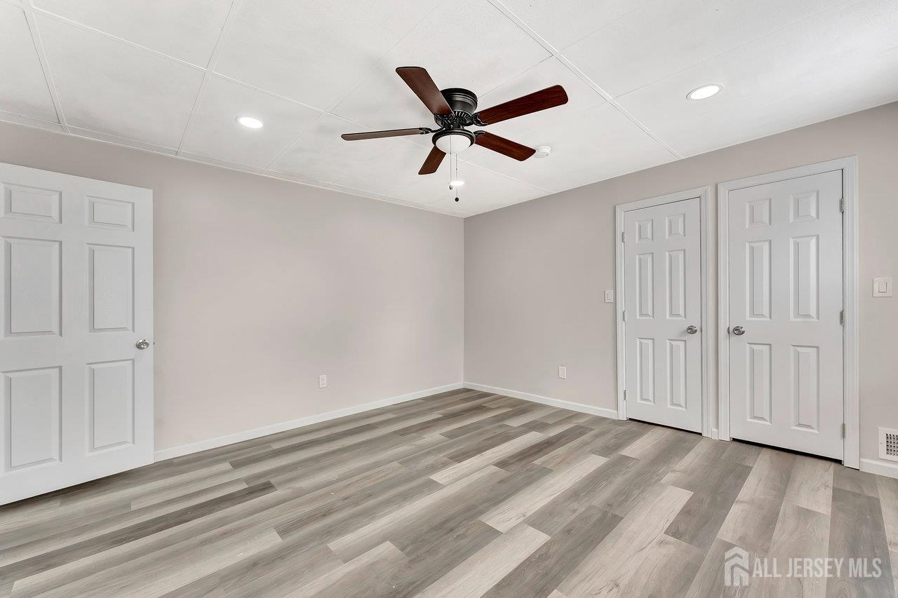 601 Ridgeway Avenue South Amboy, NJ 08879 - Photo 26 of 36 wooden floor in an empty room with a ceiling fan