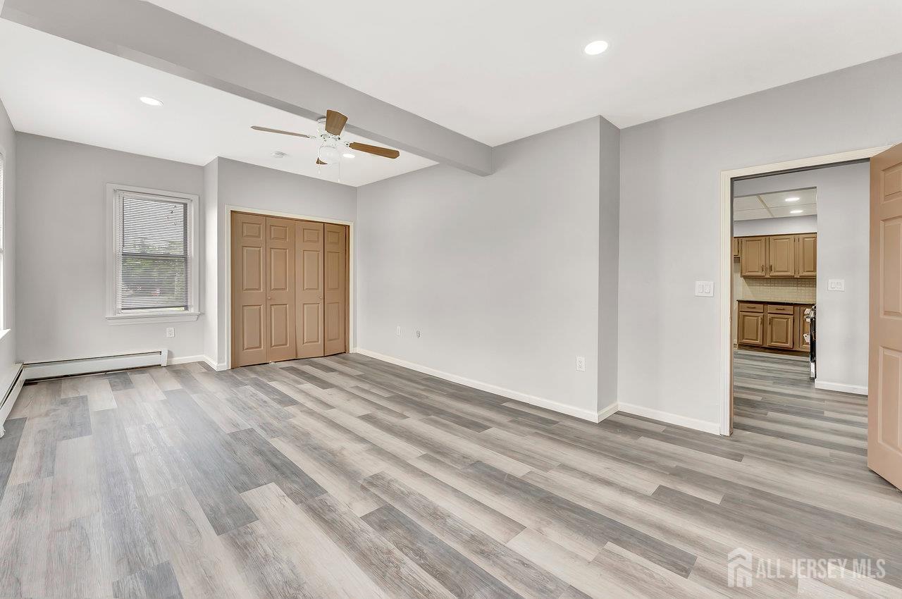 601 Ridgeway Avenue South Amboy, NJ 08879 - Photo 9 of 36 a view of an empty room with wooden floor and a window