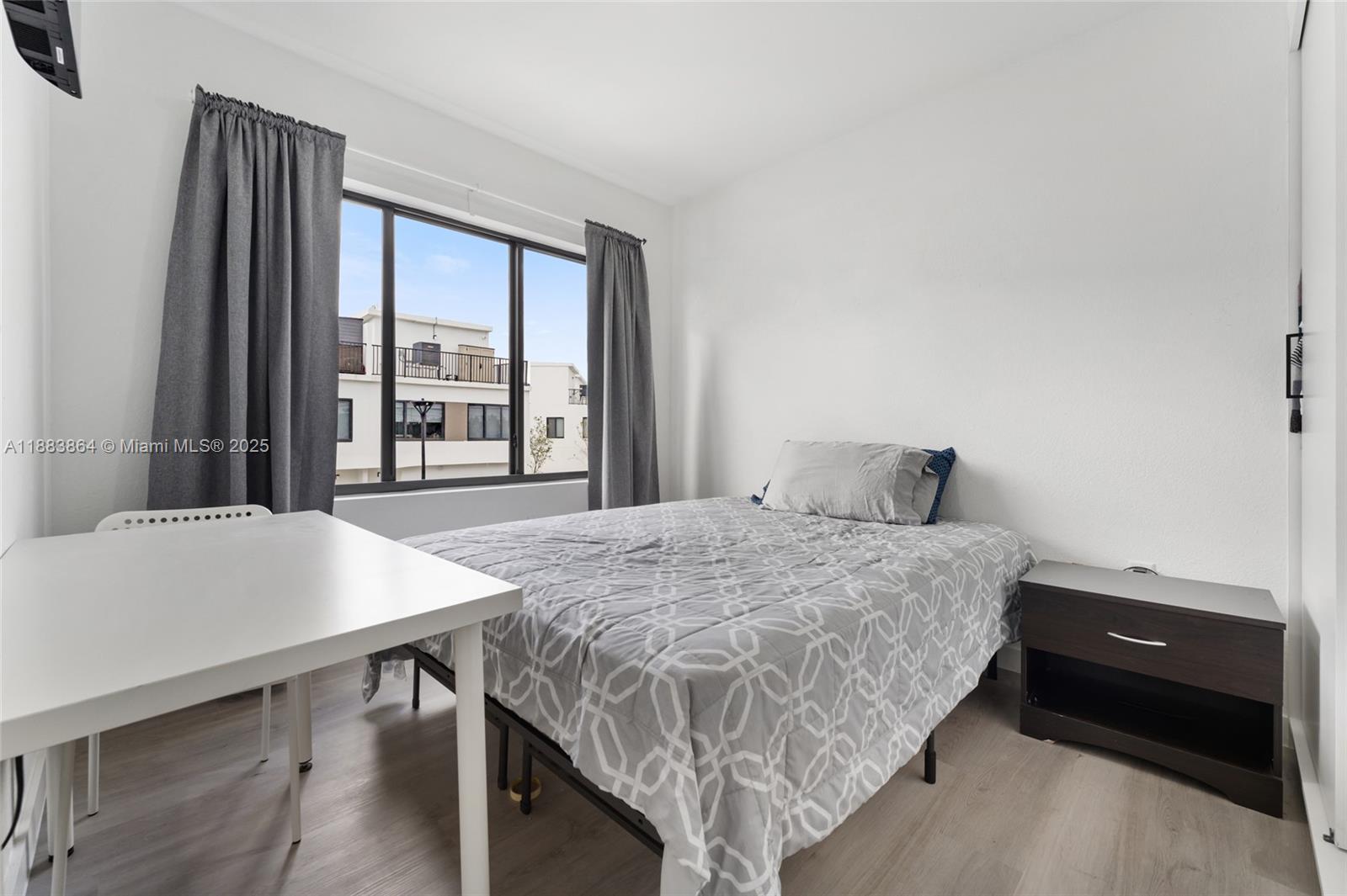 14590 Southwest 260th Street Homestead, FL 33032 - Photo 13 of 23 a bedroom with a bed and a table