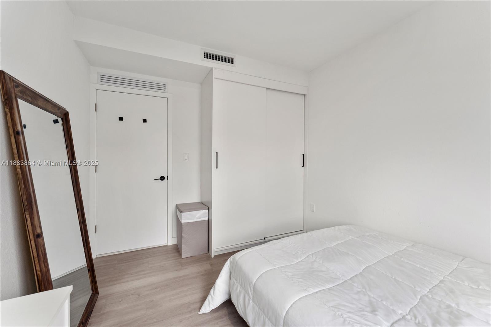 14590 Southwest 260th Street Homestead, FL 33032 - Photo 15 of 23 a bedroom with a bed and a mirror