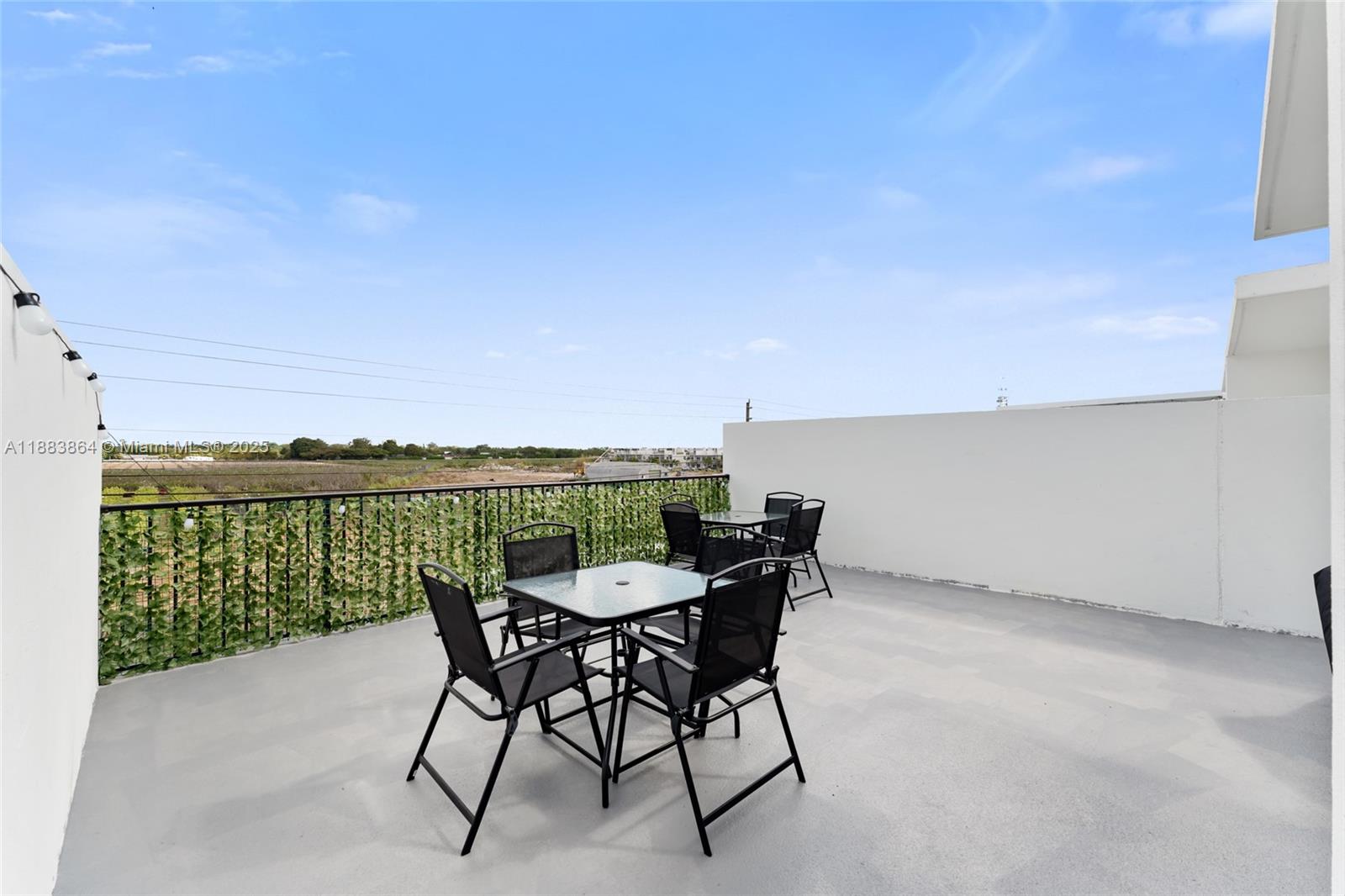 14590 Southwest 260th Street Homestead, FL 33032 - Photo 19 of 23 a terrace with a table and chairs