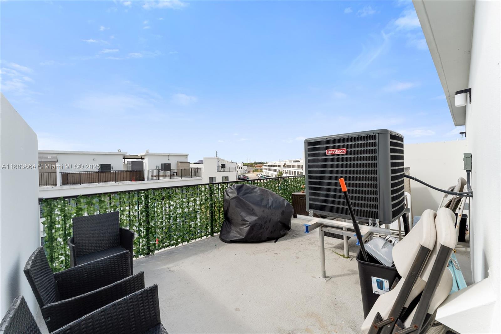 14590 Southwest 260th Street Homestead, FL 33032 - Photo 22 of 23 a balcony with a potted plant on wooden floor and city view