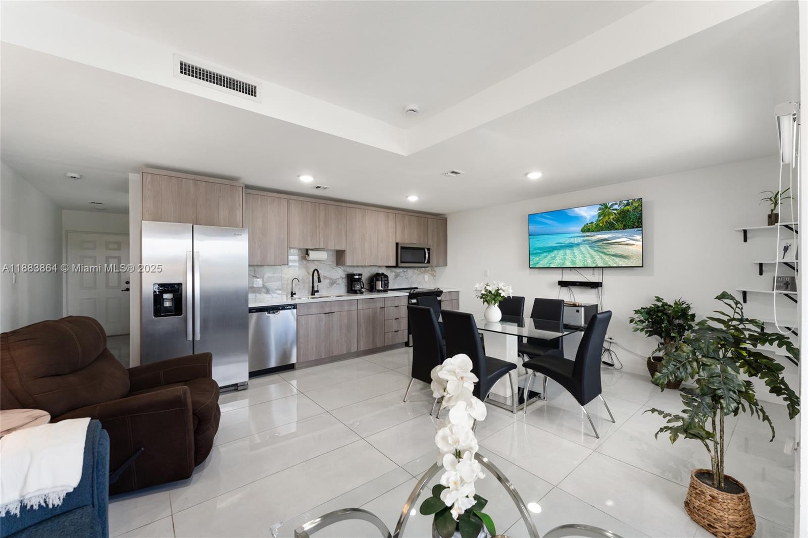 14590 Southwest 260th Street Homestead, FL 33032 - Photo 3 of 23 a living room with furniture kitchen view and a potted plant