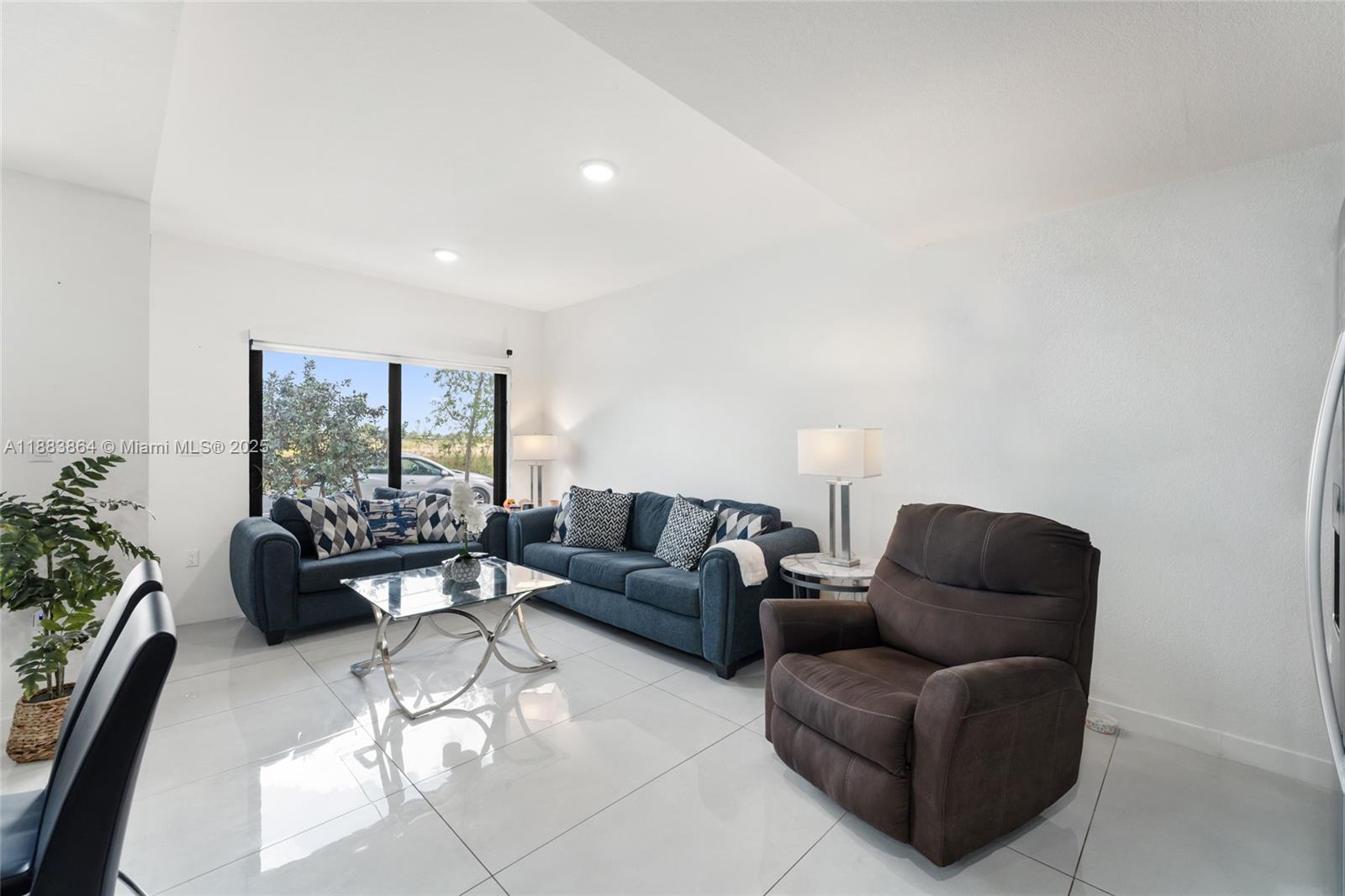 14590 Southwest 260th Street Homestead, FL 33032 - Photo 6 of 23 a living room with furniture and a large window
