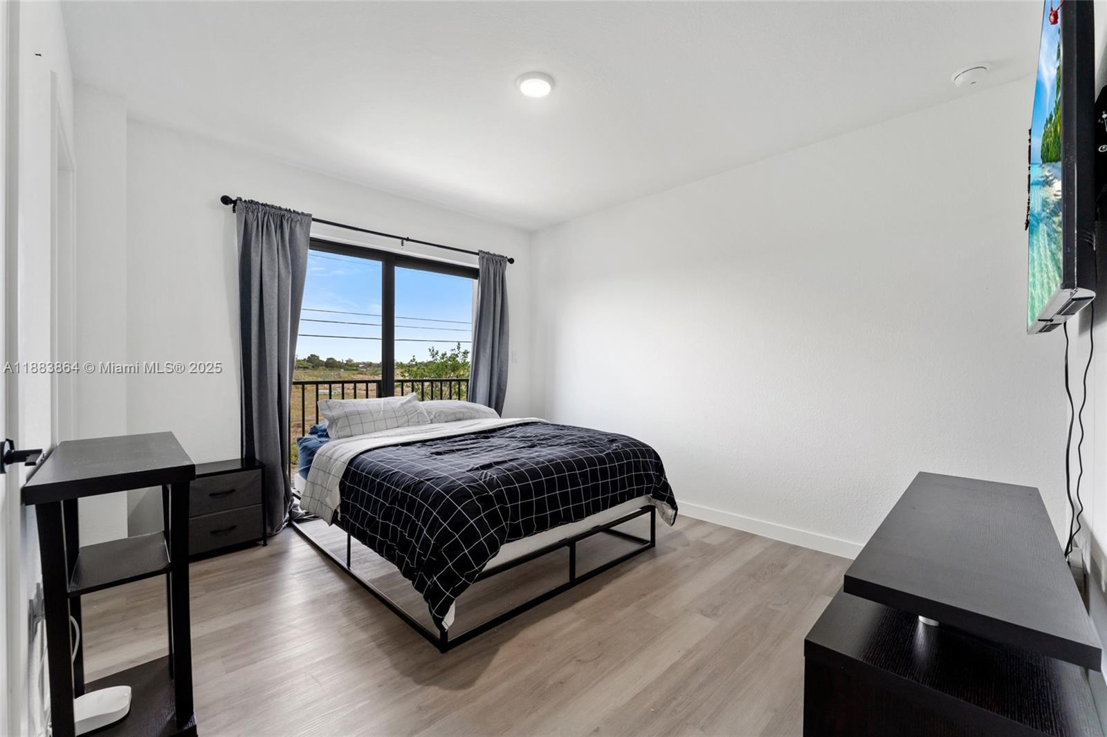 14590 Southwest 260th Street Homestead, FL 33032 - Photo 10 of 23 a living room with a bed furniture and a window