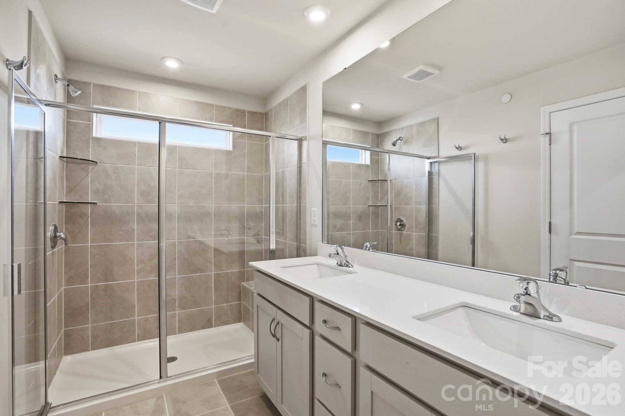2540 Hedgecliff Road Kannapolis, NC 28083 - Photo 16 of 22 a bathroom with a shower sink and mirror