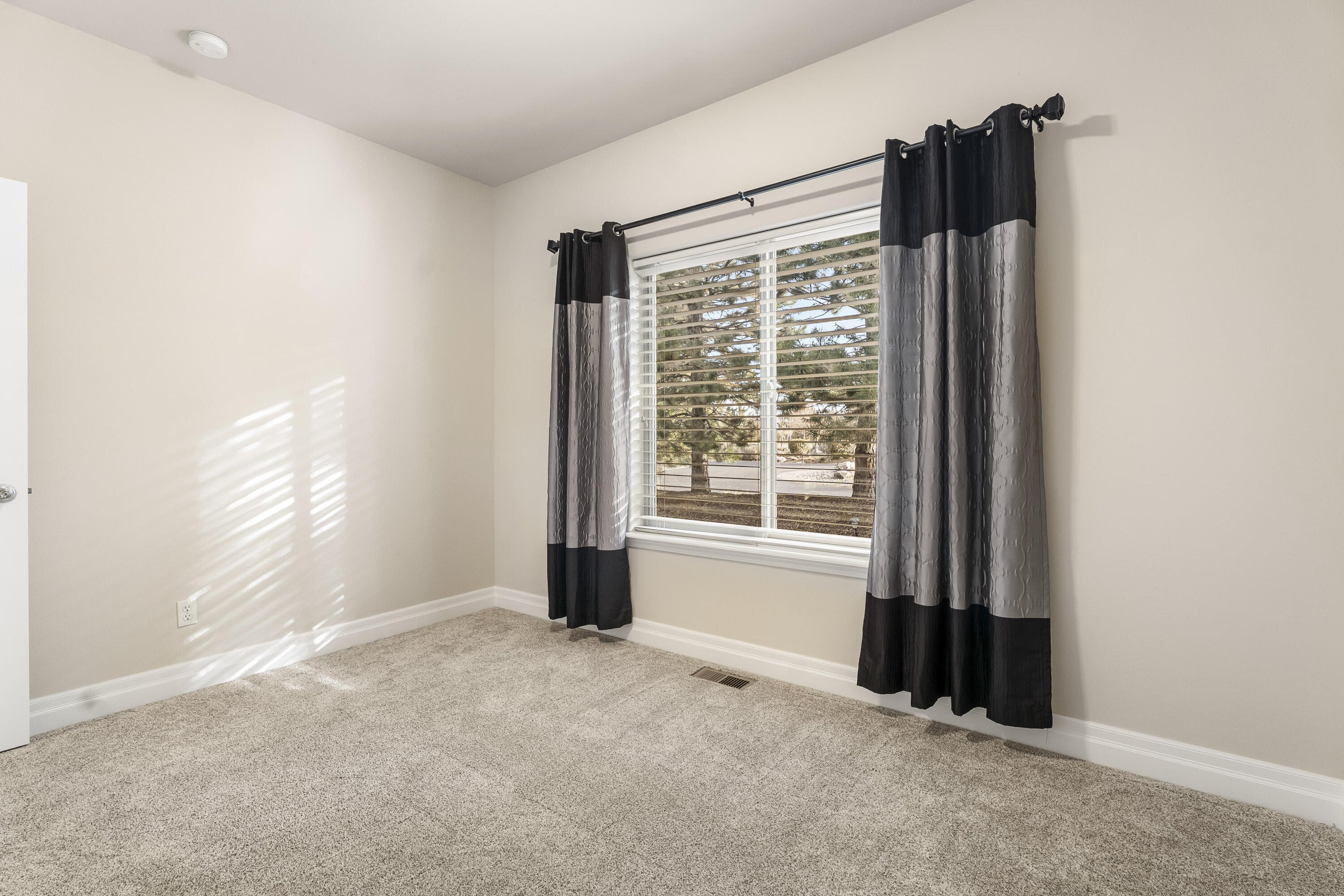 784 Ribbon Falls Road Redmond, OR 97756 - Photo 18 of 79 a view of an empty room with a window