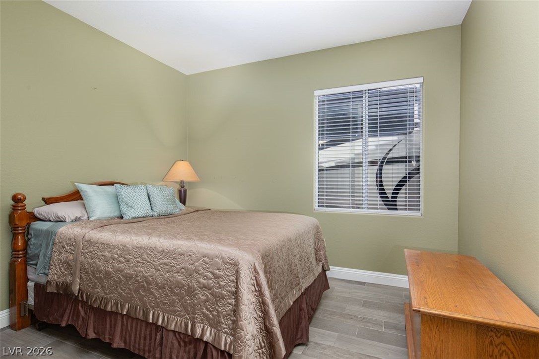 4670 Los Rancheros Avenue Las Vegas, NV 89129 - Photo 34 of 57 Large window illuminates this cozy bedroom space completed with durable tile flooring.