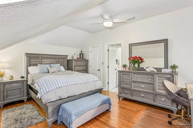 a spacious bathroom with a sink a toilet and a large mirror