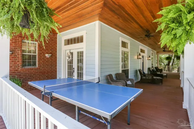 a view of house with deck and seating space