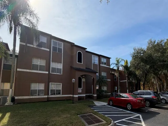 a view of a cars park in front of a building