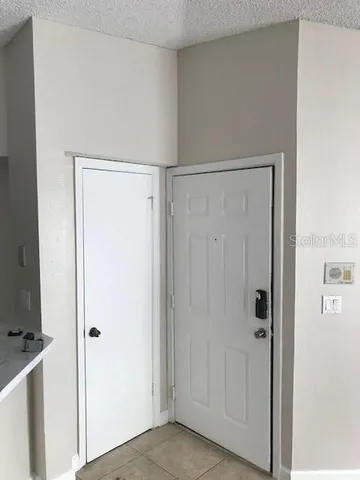 an empty room with wooden floor and entrance