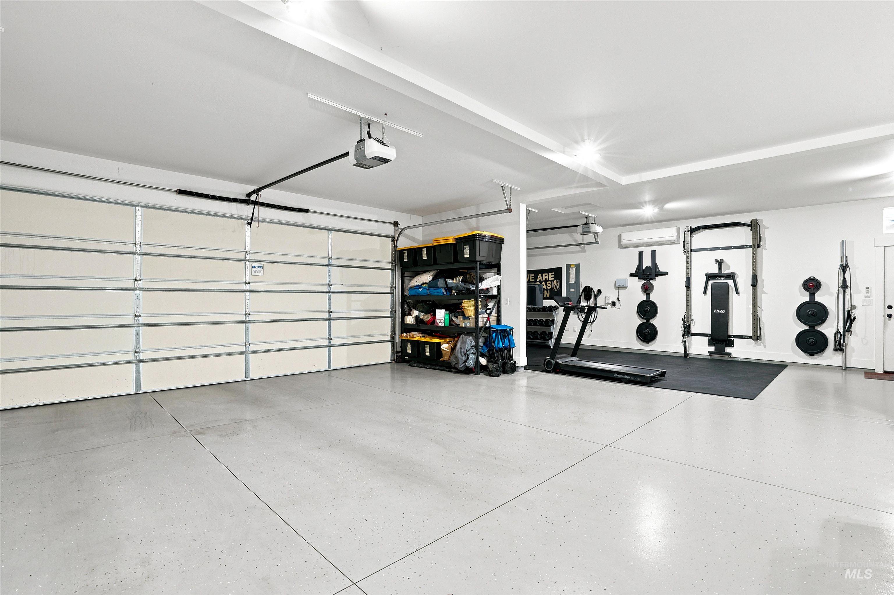 4323 West Ladle Rpds Drive Meridian, ID 83646 - Photo 41 of 49 Spacious garage featuring a light-toned, durable flooring surface, multiple overhead lighting fixtures, and a prominent garage door