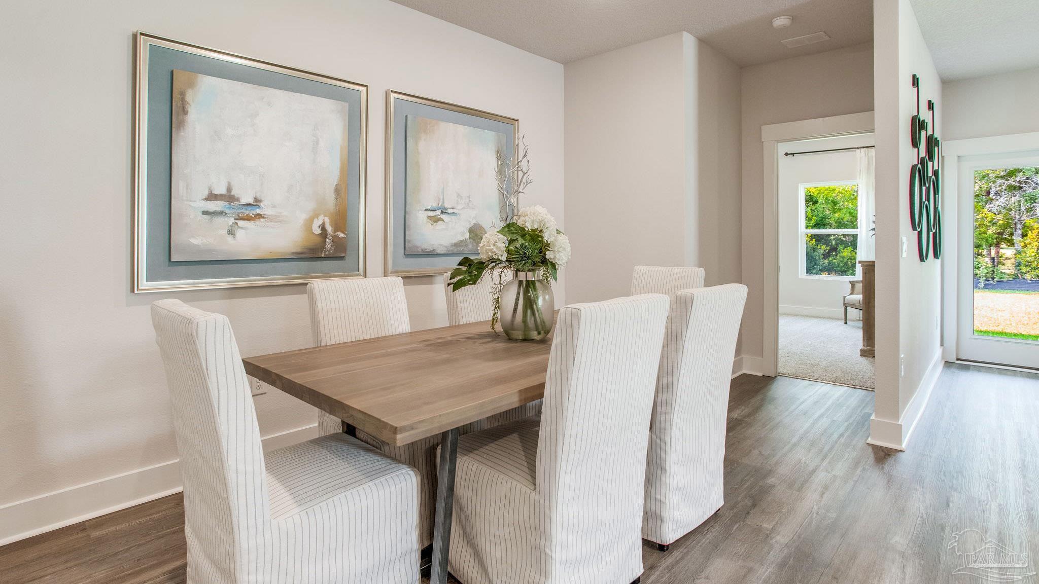 4631 Eider Road Pace, FL 32571 - Photo 12 of 46 a view of a dining room with furniture window and wooden floor