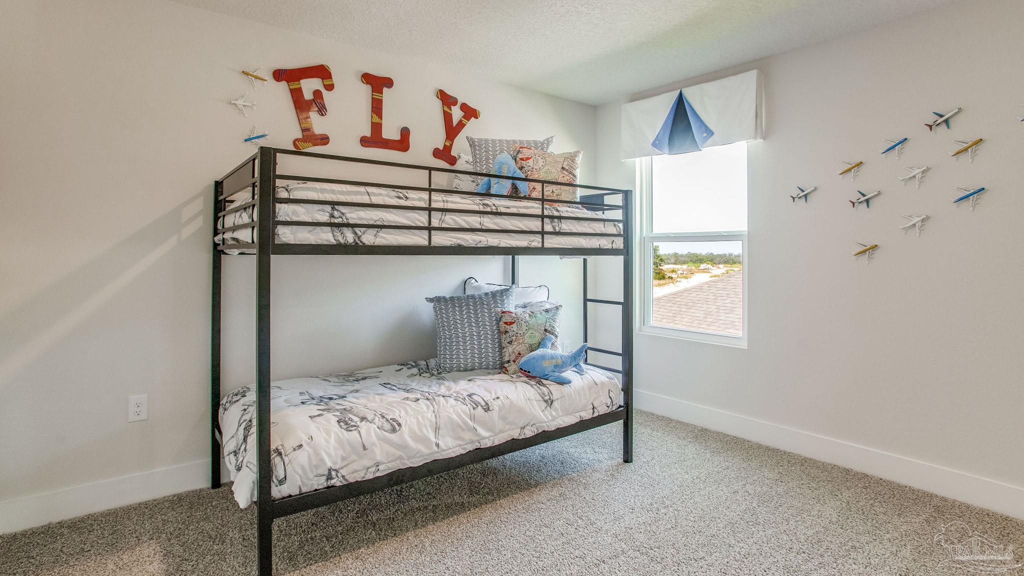 4631 Eider Road Pace, FL 32571 - Photo 18 of 46 a bedroom with a bed and window