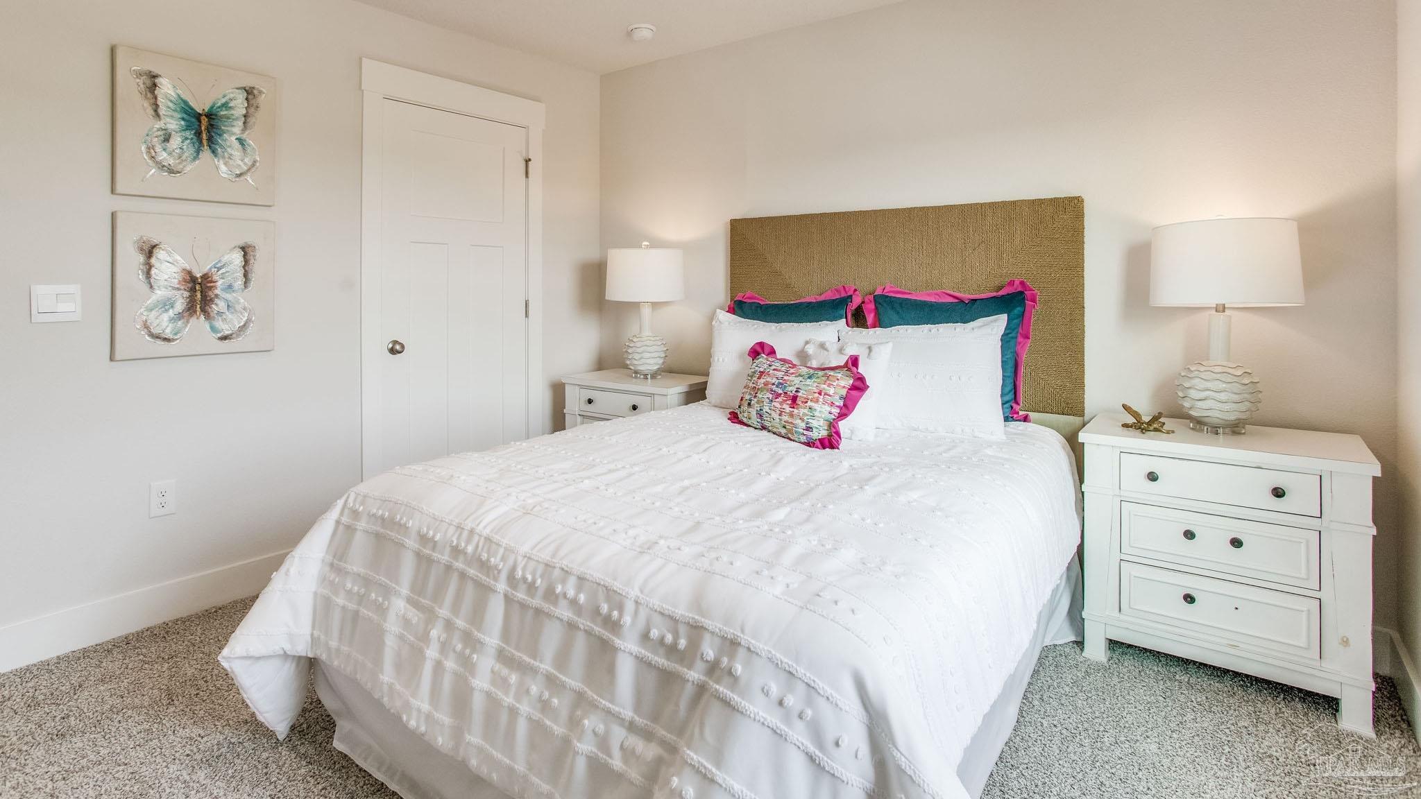 4631 Eider Road Pace, FL 32571 - Photo 22 of 46 a bedroom with a bed and a lamp on dresser