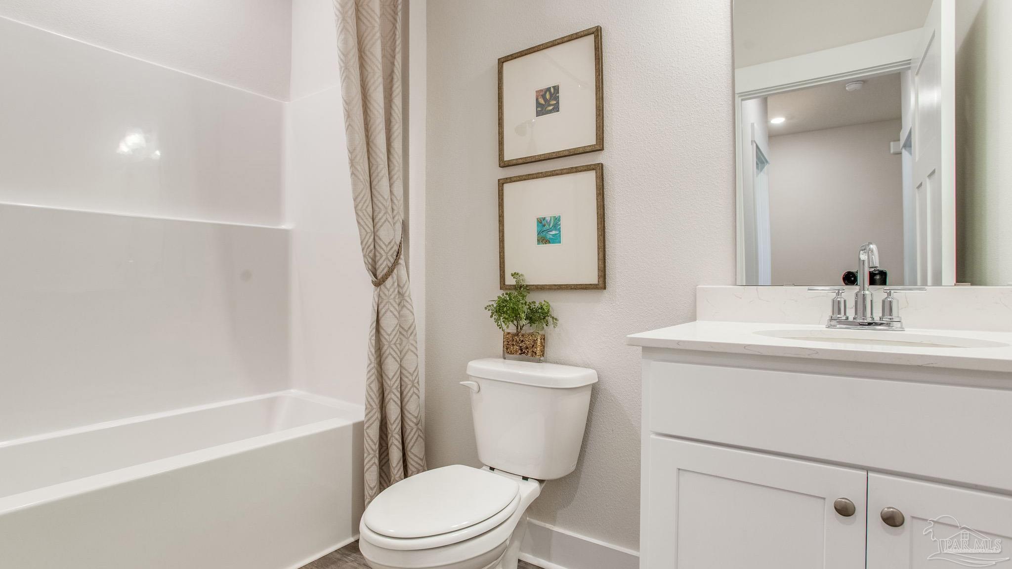 4631 Eider Road Pace, FL 32571 - Photo 24 of 46 a bathroom with a sink a toilet and shower
