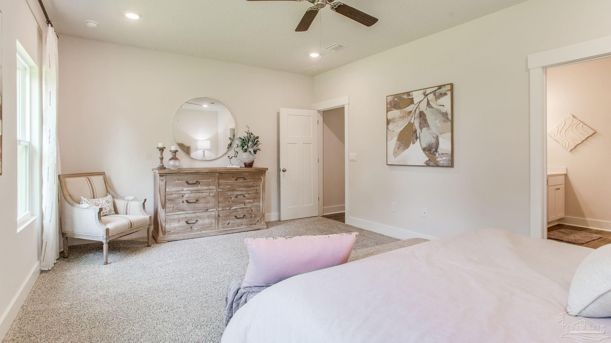 4631 Eider Road Pace, FL 32571 - Photo 30 of 46 a bedroom with a bed a couch and a view of bathroom