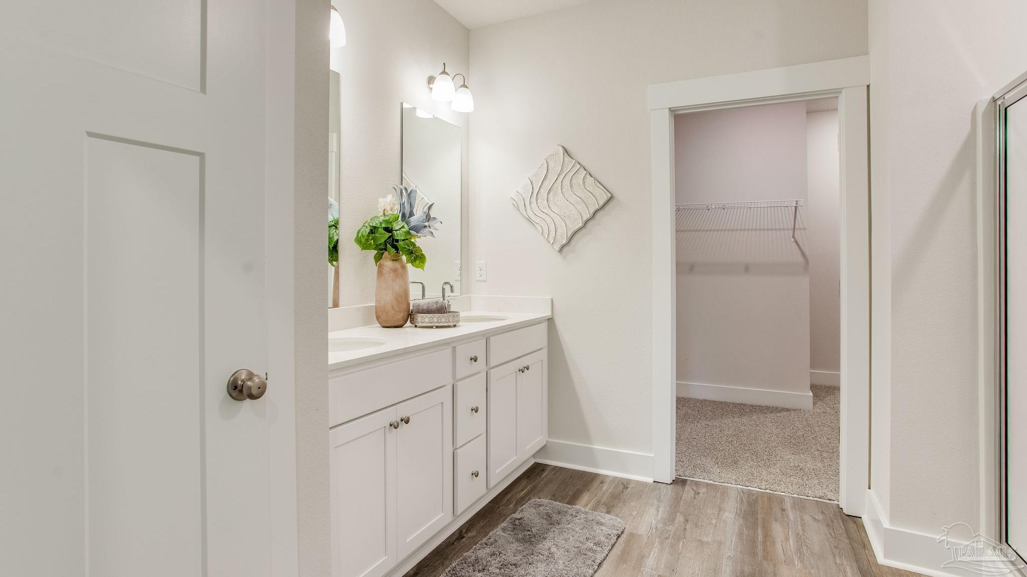 4631 Eider Road Pace, FL 32571 - Photo 31 of 46 a bathroom with double vanity sink a mirror and a shower