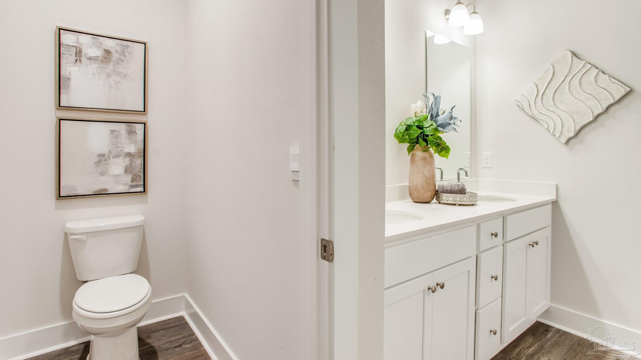 4631 Eider Road Pace, FL 32571 - Photo 32 of 46 a bathroom with a toilet a sink and mirror