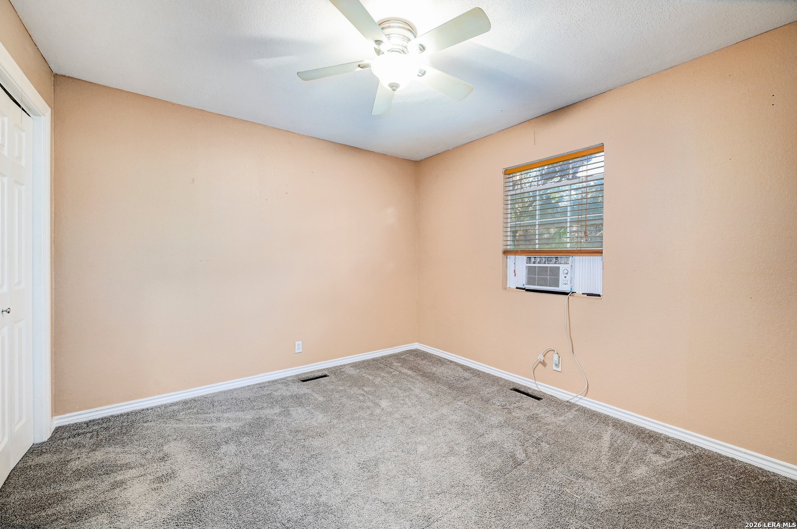 1125 Highpoint Lane Spring Branch, TX 78070 - Photo 19 of 25 an empty room with a window and a ceiling fan