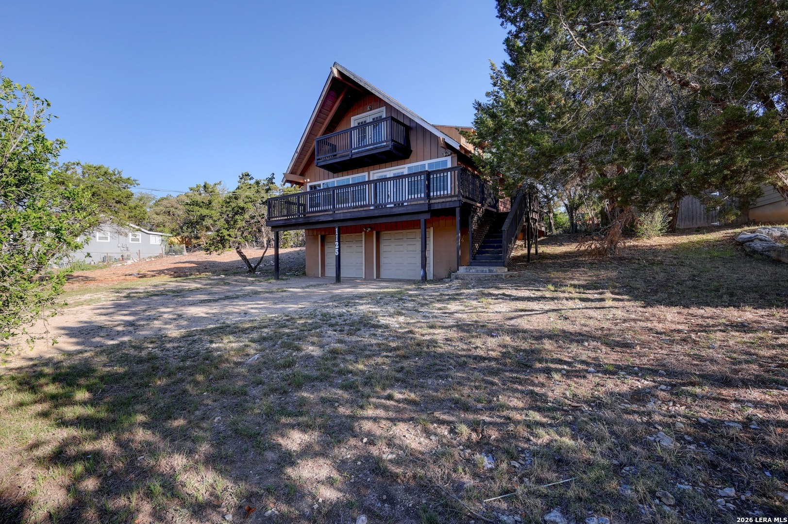 1125 Highpoint Lane Spring Branch, TX 78070 - Photo 5 of 25 a front view of a house with a wooden fence