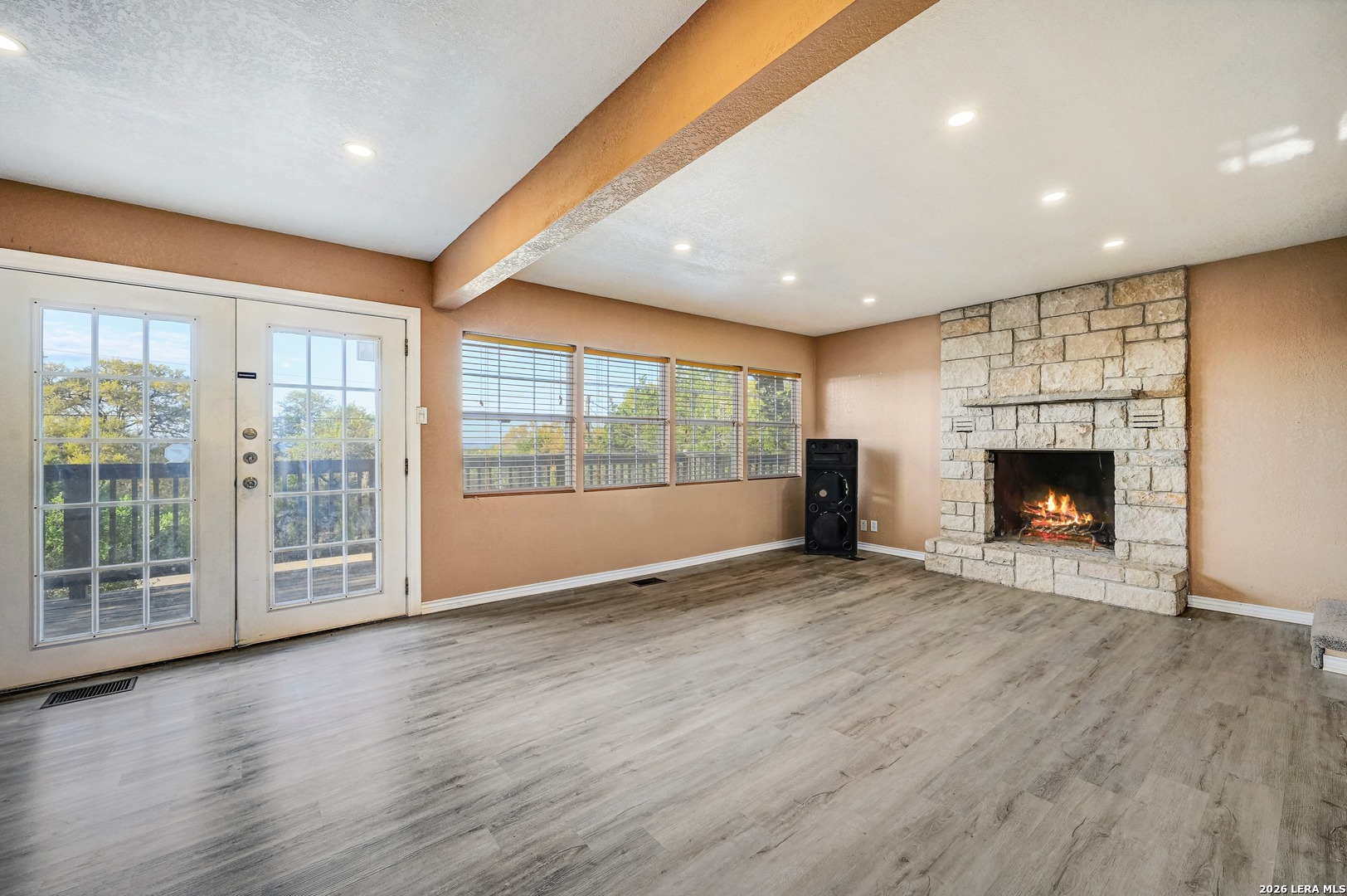 1125 Highpoint Lane Spring Branch, TX 78070 - Photo 6 of 25 a view of an empty room with wooden floor and a fireplace