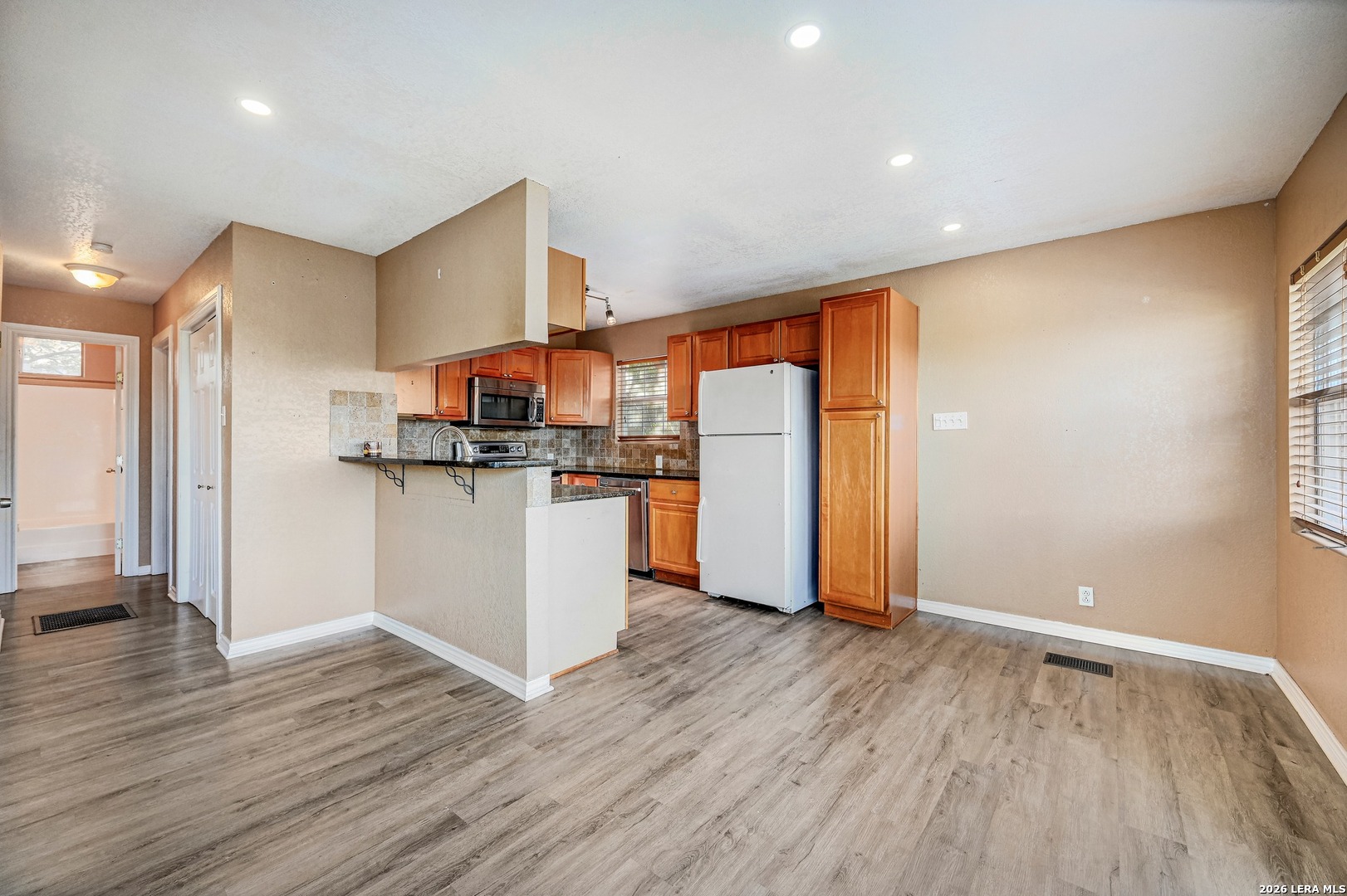 1125 Highpoint Lane Spring Branch, TX 78070 - Photo 8 of 25 a view of kitchen with stainless steel appliances wooden floor and a window