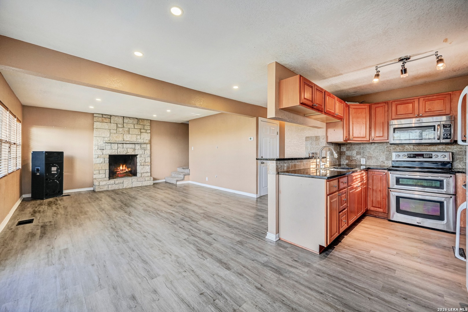 1125 Highpoint Lane Spring Branch, TX 78070 - Photo 9 of 25 a kitchen with a refrigerator and a stove top oven