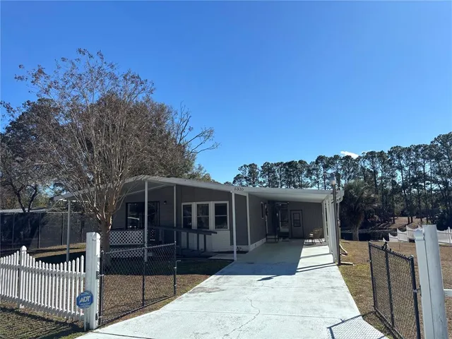 a view of a house with a backyard