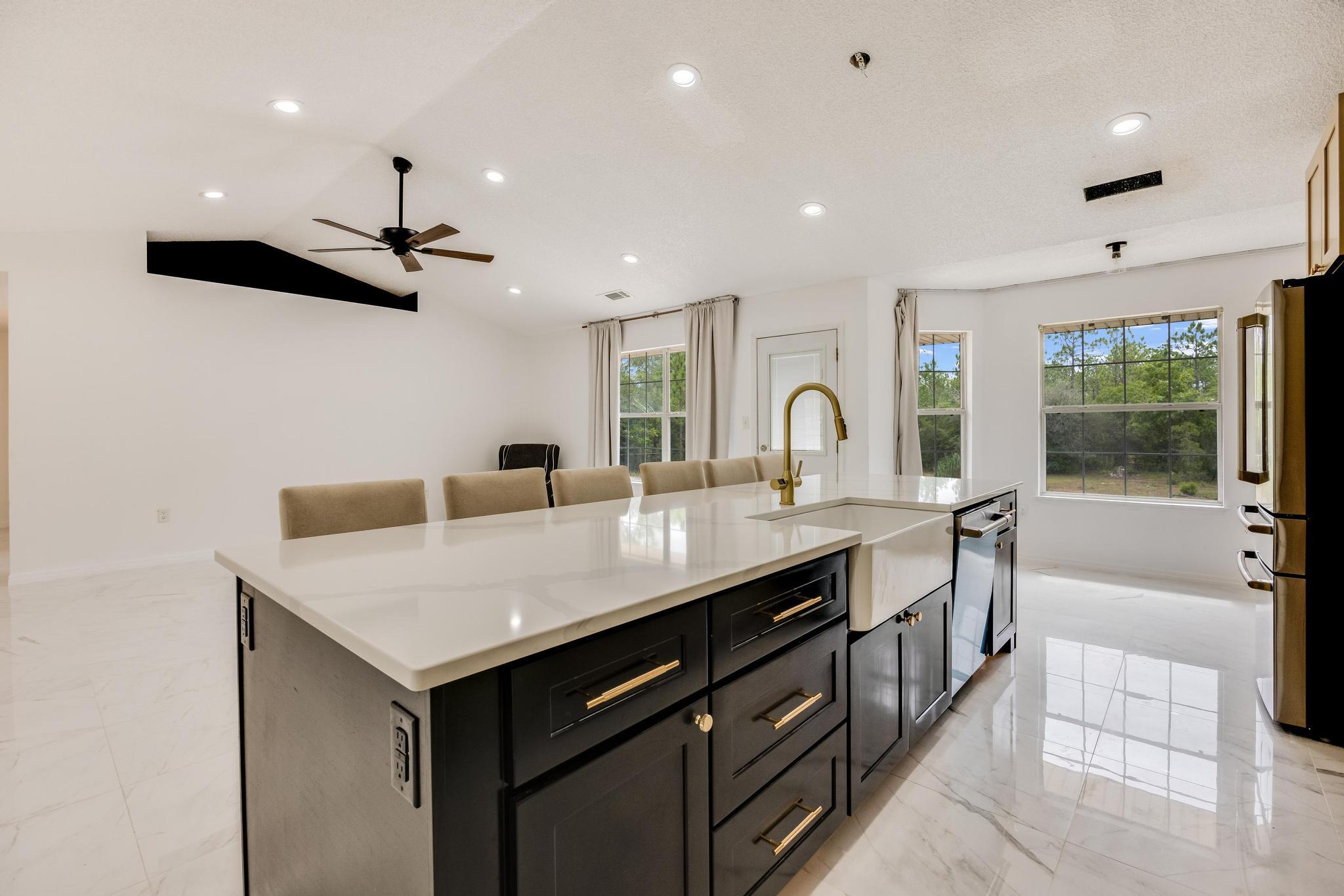 4140 Big Buck Trail Crestview, FL 32539 - Photo 11 of 40 a kitchen with a sink a stove a refrigerator and cabinets
