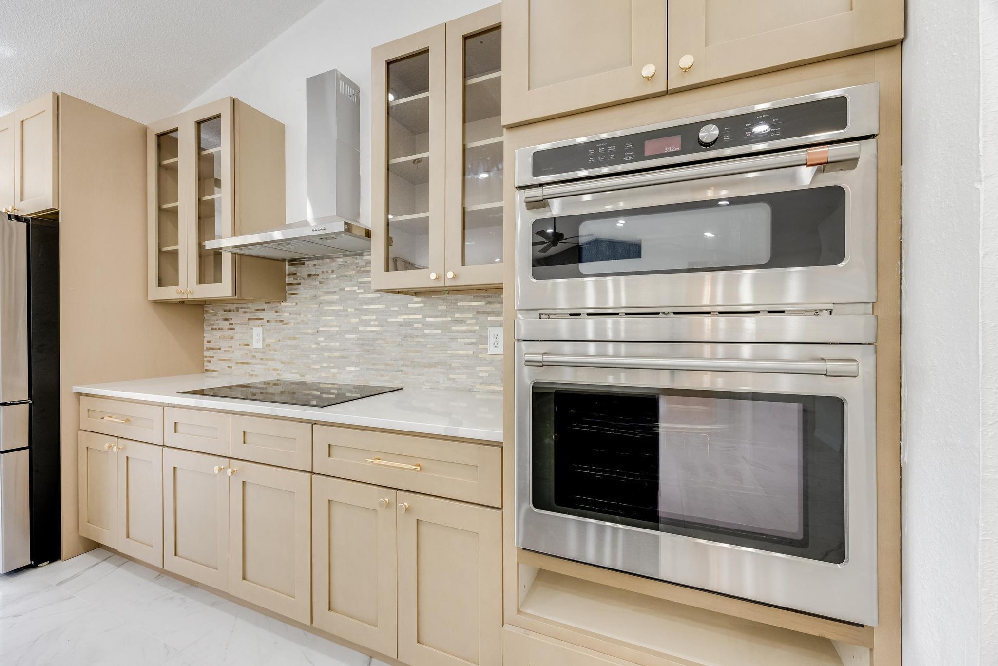 4140 Big Buck Trail Crestview, FL 32539 - Photo 12 of 40 a kitchen with granite countertop white cabinets and white stainless steel appliances