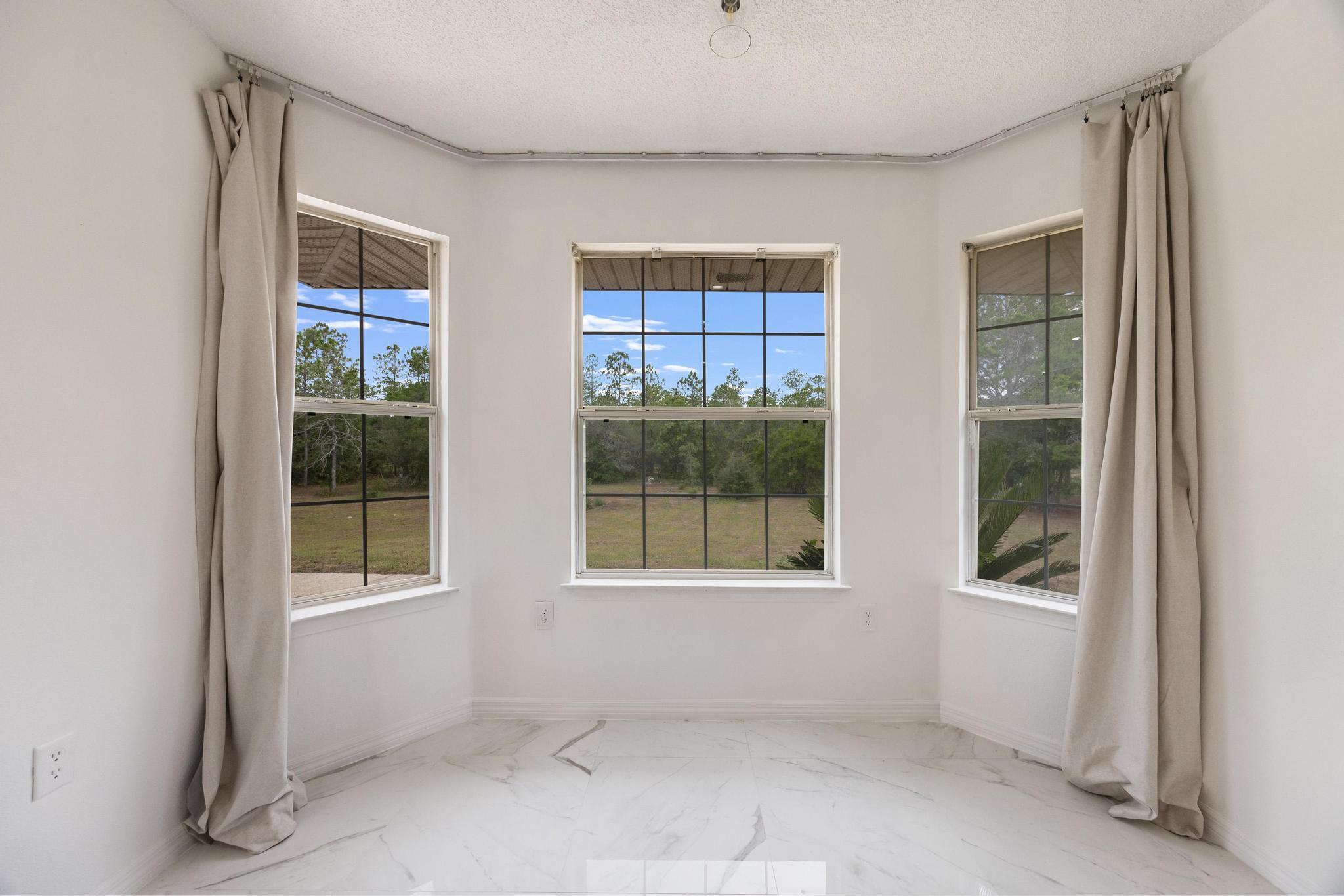 4140 Big Buck Trail Crestview, FL 32539 - Photo 16 of 40 an empty room with windows