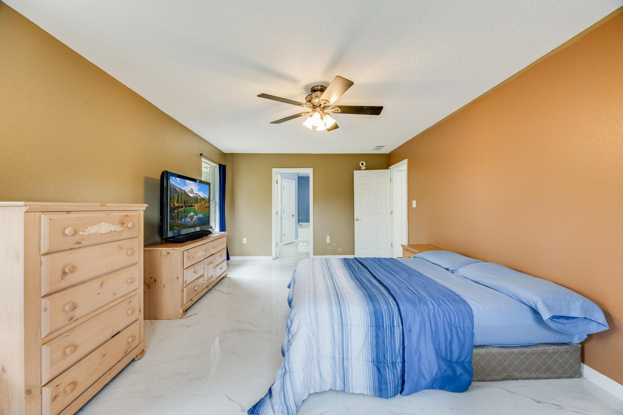 4140 Big Buck Trail Crestview, FL 32539 - Photo 23 of 40 a bedroom with a bed and a flat screen tv
