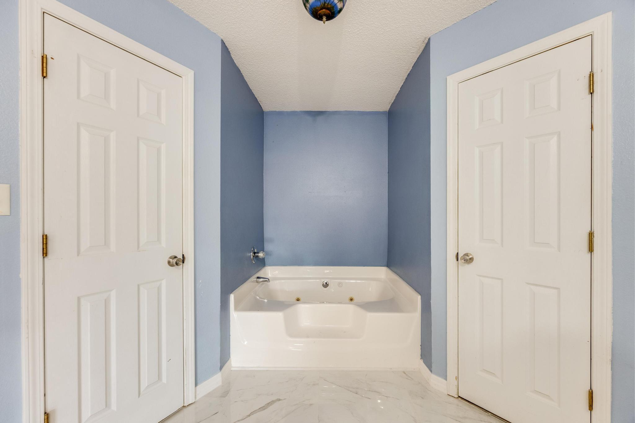 4140 Big Buck Trail Crestview, FL 32539 - Photo 25 of 40 a bathroom with a tub and shower