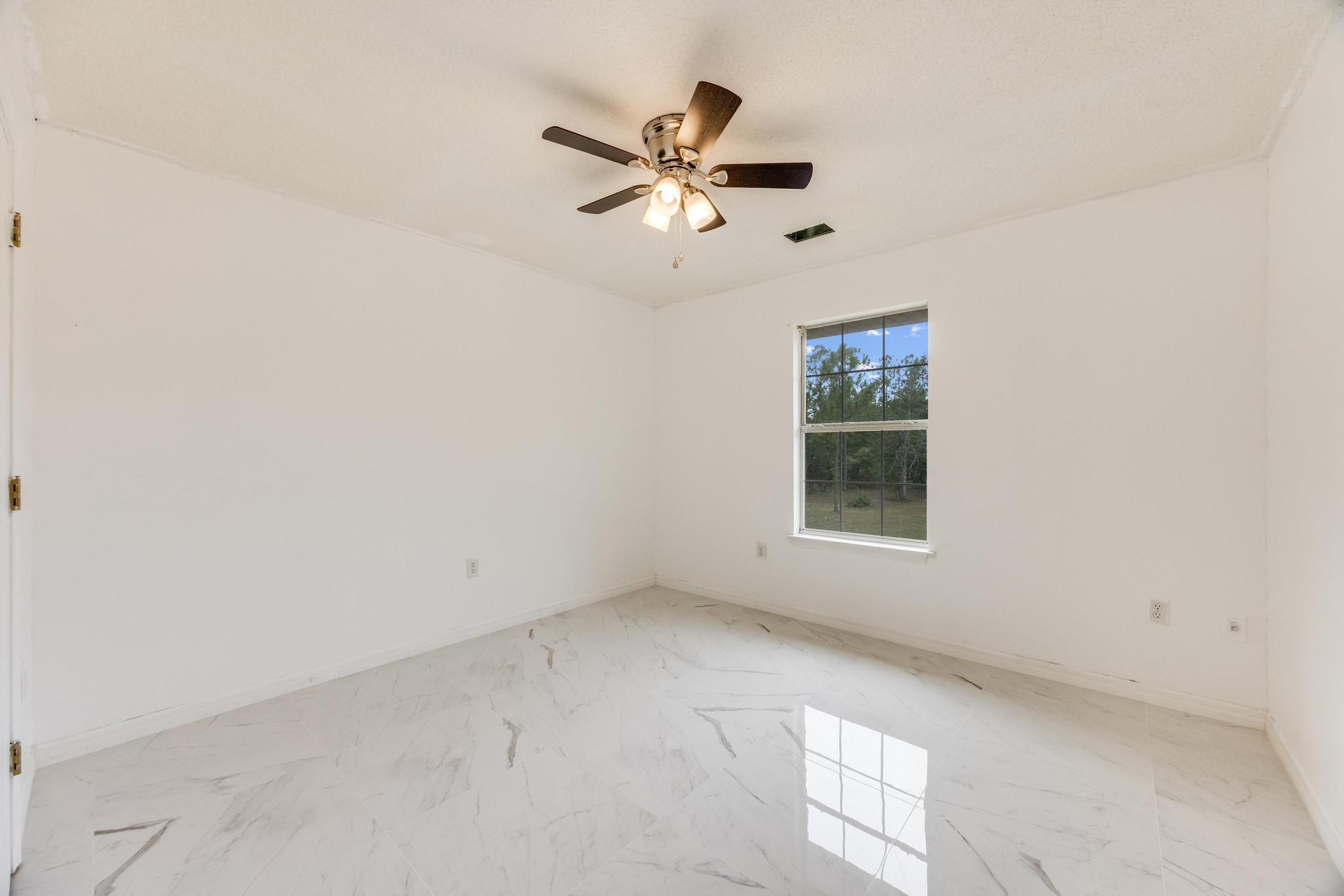 4140 Big Buck Trail Crestview, FL 32539 - Photo 28 of 40 an empty room with window and ceiling fan